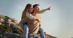 Piggyback, happy and a couple at the beach for a date, love and laughing together in Spain. Smile, summer and a pointing man and woman speaking with fun, bonding and walking by the sea for a holiday