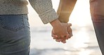 Support, love and couple at the beach holding hands for security, hope and kindness in nature closeup. Zoom, trust and man with woman at sea for care, empathy or help on travel, sea or outdoor trip