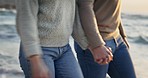 Couple, closeup and holding hands at the beach for walking, bond and travel, holiday or vacation in nature. Zoom, love and man with woman at the ocean with trust, support and unity, care and sea trip