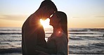 Silhouette, couple and travel, sunset at the beach and love with bonding, romantic date outdoor with hug or dancing. Man, woman and healthy relationship with adventure, forehead touch, sea and trust