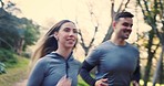 Forest, running and couple with wellness, fitness and motivation with training, workout and challenge. Healthy people, man and woman in the woods, runner or sports with exercise, cardio and fresh air