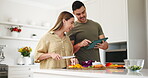 Food, tablet and a couple cooking in the kitchen of their home together for health or nutrition. Diet, love or smile with a man and woman preparing a meal with vegetables for wellness or hunger