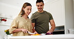 Food, diet and a couple cooking in the kitchen of their home together for health or nutrition. Recipe, love or smile with a man and woman preparing a meal with vegetables for wellness or hunger