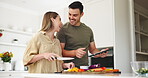 Tablet, health and a couple cooking in the kitchen of their home together for health or nutrition. Love, food or diet with a man and woman preparing a meal with vegetables for wellness or hunger