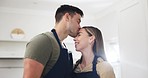 Couple, kiss and feeding food in kitchen for romance, healthy marriage and nutrition. A happy man and woman cooking and eating a strawberry fruit with love for diet, taste or vegan snack in a house