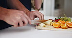 Fruit, healthy and hands of couple cooking together in a kitchen bonding in a home, house or apartment. Closeup, man and woman preparing food for lunch or brunch as nutrition to relax in the weekend