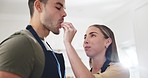 Couple, food and feeding fruit in home kitchen for romance, healthy marriage and nutrition. A happy man and woman cooking and eating a strawberry with love for diet, taste or vegan snack in a house