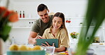 Tablet, recipe and a couple cooking food in their kitchen together for health, wellness or nutrition. Technology, health or diet with a man and woman in their house to prepare a meal for supper