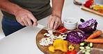 Hands, knife and cutting vegetables in kitchen, home and ready with cooking, preparation and nutrition. Man, diet and mushrooms with vegan meal, food or healthy product for dinner, brunch or wellness