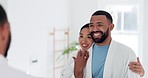 Hug, smile and young couple in the bathroom for health, wellness and morning routine together. Happy, mirror and interracial man and woman embracing before self care treatment at modern apartment.