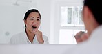 Brushing teeth, mirror and woman in home bathroom, health and wellness in house. Dental, toothbrush cleaning and reflection of Asian person for oral care, mouth hygiene and toothpaste in the morning