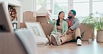 Happy couple, boxes and relax in new home, property or investment together on living room floor. Excited man and woman smile, thinking or idea in house renovation, relocation or real estate apartment