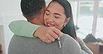 Happy couple, real estate and hug with keys in new home, property or moving in together. Excited man and woman smile in embrace for relationship, investment or start in house, goals or apartment