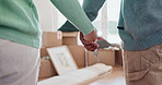 Couple, hands and keys to new house with commitment, love and moving in together. Security, support and man and woman holding hands for investment or mortgage, rent or loan for real estate property