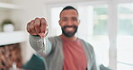 Happy man, real estate and keys in new home, property or building investment in living room. Portrait of male person or homeowner smile in happiness for house loan, buying or  moving in apartment