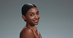 Happy, skincare and face of a woman on a studio background with a dermatology glow. Smile, Indian and a young girl or model with a portrait for wellness and health of skin with beauty from a spa