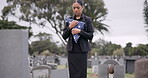 Funeral, death and a sad woman with an american flag at a cemetery in mourning at a memorial service. Sad, usa and an army wife as a widow in a graveyard alone feeling the pain of loss or grief