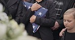 Funeral, cemetery and woman with American flag for veteran for respect, ceremony and memorial service. Family, depression and sad people by coffin in graveyard for military, army and soldier mourning