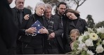 Funeral, graveyard and sad family with American flag for veteran for comfort, ceremony and memorial service. War hero, depression and people by coffin in cemetery mourning military, army and soldier