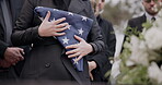 Hands, american flag and death with a person at a funeral, mourning a loss in grief at a graveyard. War, cemetery and an army wife at a memorial service to say goodbye to a fallen soldier closeup