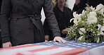 USA veteran funeral, woman and casket with touch, sad family and flag for mourning, depression and respect. Widow, people and army service with coffin, burial or memorial for war hero in Philadelphia