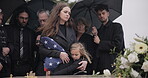 Funeral, family and sad people with American flag, grief and mourning death, burial and widow depressed at farewell event. Kid, mother and group gathering at coffin, casket and crying at ceremony