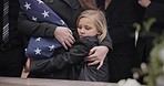 USA veteran funeral, child and sad family with hug, care and flag for mourning, depression and comfort with mom. Girl, people and service with coffin, burial or memorial with war hero in Philadelphia