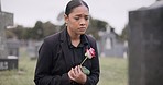 Sad woman, rose and graveyard in loss, grief or mourning at funeral, tombstone or cemetery. Female person with flower in depression, death or goodbye at memorial or burial service for loved one