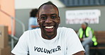 Happy black man, volunteer and community service with smile in NGO, charity or teamwork. Portrait of African male person, face or volunteering worker in happiness for distribution and contribution