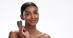 Gua sha, face and woman with skincare, beauty and cosmetics isolated on a white studio background. Portrait, person and model with rose quartz, shine and wellness with dermatology, glow and wellness