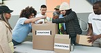 Happy people, volunteer and donation box in NGO, charity or team in community service together. Group of volunteering workers packing parcel, package or boxes in teamwork, society or contribution