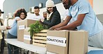 People, volunteer and box in donations, community service or charity together in team NGO. Group of volunteering workers packing parcel, package or boxes in teamwork, non profit or contribution