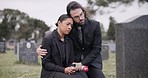 Sad couple, rose and graveyard in loss, grief or mourning at funeral, tombstone or cemetery. Man and woman hug with flower in depression, death or goodbye at memorial or burial service for loved one