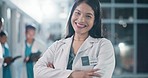 Woman, face and doctor with arms crossed in healthcare services, surgery or help in busy hospital at night. Portrait of happy surgeon, expert therapist or medical professional working late with trust