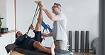 Physiotherapy, man and stretching muscle in legs with a resistance band, equipment or healing exercise with therapist. Physical, rehabilitation and patient training with support of physiotherapist
