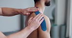 Physiotherapy, shoulder strap and man patient with sport massage therapist and arm injury at clinic. Healthcare, support and chiropractor with exercise and fitness rehabilitation in a consultation