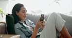 Woman, relax and typing on smartphone on sofa, scroll social media and reading notification at home. Cellphone user, connection and search website, download digital app or mobile games in living room