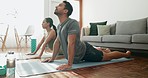 Couple, yoga and cobra pose in living room, fitness and bonding with love, care and exercise. Pilates, wellness with man and woman workout together at home, body stretching with health and zen