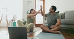 Yoga, laptop and high five with a couple on the living room floor of their home together for support or fitness. Exercise, motivation or success with a man and woman laughing during an online class