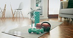 Dumbbells, floor and water bottle on yoga mat, home and hydration for training, wellness or health. Workout equipment, living room and headphones for music, inspiration or audio streaming for fitness
