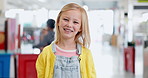 Face, happy girl and student in kindergarten, learning and knowledge of education. Portrait smile, cute kid and child in school for studying, development and adorable in hallway of nursery classroom