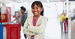 Face, arms crossed and a student girl at a science fair for education, growth or child development. Portrait, smile and learning with a happy young kid at a school closeup for research or experiment