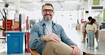Face, man and teacher smile in kindergarten school for education on chair with glasses. Portrait, confident educator and mature person happy for learning, knowledge or professional study in preschool