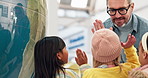 School, children and high five from teacher in class learning about geography, world map and globe with kids together in lesson. Students, group and man with support, praise and success in teaching