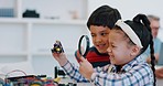 School kids, magnifying glass and electronics in class, tech and inspection for circuit, thinking and innovation. Girl, boy and check with lens for robotics, future and happy for education at academy