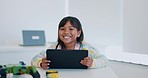 Technology, education and child with tablet at desk, elearning and development at school with smile. Digital app, internet and happy girl at table with tech for learning website and virtual classroom