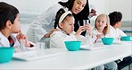 Education, science and teacher with children in a class for an experiment, study or research. Knowledge, chemistry and woman scientist working with kid students for chemical reaction in a school lab.