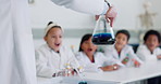 Science, education and hand of a teacher for a chemical reaction in class with student children. School, learning or study and kids in a classroom research or an experiment with a scientist closeup
