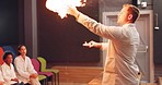 Science, man and fire with children and teacher for education, learning and an exhibition. Chemistry, school and a male scientist with a flame, innovation and teaching physics to students at a museum