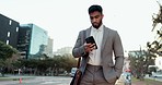 Phone, walking and young businessman in the city scroll on social media, mobile app or the internet. Technology, professional and male lawyer browsing on cellphone for commuting in an urban town road